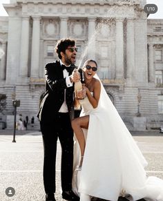 a man in a tuxedo standing next to a woman in a wedding dress