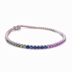 This beautiful Rainbow Sapphire Bracelet is made with Natural Sapphires and Solid Gold! Perfect for both - casual & occasion wear. ◆ Stone Details ◆ Stone: Natural Rainbow Sapphires Stone Shape: Round Stone Size: 2.5mm Stone Weight: 6 cts (approx) ◆ Metal Details ◆ Metal: 10K, 14K, 18K Gold Color: White Gold Length: 6 to 8.5 inches ◆ Shipping Details ◆ Via FedEx Express Made to Order & Shipped within 10 Days Delivery: Within 7 Days Tracking ID provided ◆ Personalization ◆ Want to change stone co Fine Jewelry Multicolor Tennis Bracelet With Jubilee Style, Multicolor Fine Jewelry Tennis Bracelet With Jubilee Style, White Gold Multi-stone Round Bracelet, Multicolor Multi-stone Tennis Bracelet As Gift, Formal Multicolor Jubilee Bracelet, Multicolor Multi-stone Round Diamond Bracelet, Multicolor Multi-stone Round Tennis Bracelet, Multicolor Gemstone Tennis Bracelet, Multicolor Multi-stone Diamond Bracelet