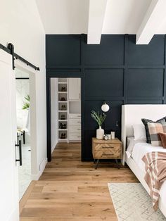 a bedroom with blue walls and wooden floors