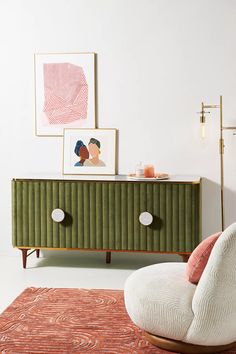 a living room with a green cabinet and pink rug