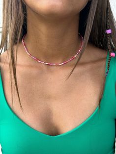 Cute pink beaded necklace! Its 14 inches around and is light and easy to wear! Party Beaded Necklaces With Heart Beads, Pink Choker With Colorful Beads For Gift, Pink Choker Necklace For Summer, Summer Pink Choker As Gift, Pink Tiny Beads Necklace For The Beach, Pink Beaded Necklace With Tiny Beads For Gift, Pink Beaded Necklace For Beach With Colorful Beads, Handmade Pink Necklaces For The Beach, Pink Colorful Beaded Necklace For The Beach