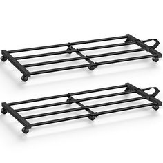 two black metal racks with wheels on them