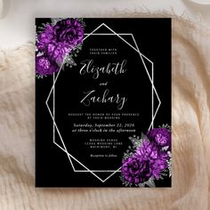 a black and purple wedding card with flowers