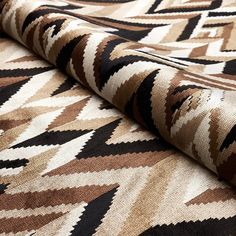 a close up view of a rug with different colors and patterns on the fabric,