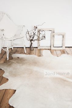 a white chair sitting on top of a wooden floor