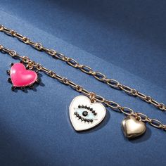 Feel the love with our Evil Eye Heart Bracelet. Crafted with a singular focus, this bracelet offers an exquisitely-crafted representation of protection and love, alluringly adorned with a delightful heart bearing an eye at its center. Ensuring that the wearer is blessed by the all-seeing eye of affection, this luxurious piece is sure to captivate and enchant. Detail Plating: 18K Gold Materials: 18K Gold on Alloy Size:  Length:6.69 "(17cm)+Extender: 2.17"(5.5cm ) Weight: 17.9g Friendship Heart Beads Jewelry, Heart Charm Jewelry For Friendship On Valentine's Day, Heart-shaped Jewelry For Valentine's Day, Valentine's Day Heart Charm Bracelet For Promise, Valentine's Day Friendship Bracelet Jewelry, Valentine's Day Promise Heart Charm Bracelet, Gold Bracelets With Heart Pendant Charms, Heart-shaped Metal Charm Bracelet For Friendship, Symbolic Gold Jewelry For Valentine's Day