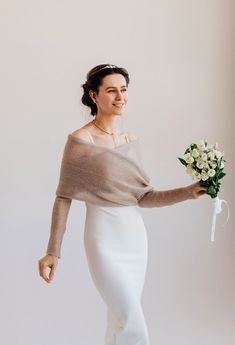 a woman holding a bouquet of flowers in her hand