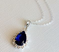 Wedding Navy Blue Dark Blue Sapphire Colored Teardrop Crystal Halo Silver Pendant Necklace with .925 Sterling Silver Chain. PLEASE READ ITEM DESCRIPTION and SHOP POLICIES before placing your order, and contact me with any questions! CHAIN is 18 inches (45.7cm) long. PENDANT is about 1.06 inch (2.7cm) including bail. BRIDAL NECKLACES SECTION: https://www.etsy.com/shop/LanaChayka?ref=seller-platform-mcnav§ion_id=11638944 NECKLACES SECTION: https://www.etsy.com/shop/LanaChayka?ref=seller-platform-m Sapphire Drop Necklace For Wedding, Blue Teardrop Necklace For Wedding, Pear-shaped Sapphire Necklace For Wedding, Sapphire Teardrop Pendant For Wedding, Blue Sapphire Bridal Necklace For Wedding, Blue Sapphire Necklace For Wedding, Navy Blue Jewelry, Crystal Wedding Necklace, Bridal Necklaces