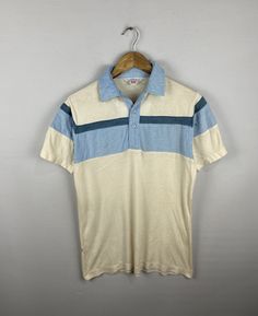 *ITEM DETAILS:Vintage 70s  Levis Collar Shirt Western Levis Stripe Polo Shirt Large  1970s Levis Rockabilly Tshirt Size L 👇🏻 Please be aware that all vintage items will usually show a few signs of wear or fading due to age, but anything visible such as stains or holes, and serious flaws have been photographed.For any further information on this item please contact us and we will be happy to help. *SIZE: LARGE  * ACTUAL SIZE MEASUREMENT: 👇🏻 *PIT TO PIT(WIDTH):24"INCHES *LENGTH(FROM SHOULDER): 28"INCHES    *ALL MEASUREMENTS ARE TAKEN WITH THE GARMENT FLAT ON THE GROUND *VIEW FULL SHOP HERE: *SHIPPING: (WITH ONLINE TRACKING NUMBER ) *DHL EXPRESS SHIPPING:4-6 BUSINESS DAYS *Don't Worry About Customs Tax or Fees. I usually Declare As 'Gifts' And Low Value  *PAYMENT (ACCEPT "PAYPAL" ONLY). * Vintage T-shirt With Retro Print And Relaxed Fit, Retro Cotton Short Sleeve Tops, Retro Collared Polo Shirt With Graphic Print, Retro Blue Collared Top, Blue Collared Retro Tops, Blue Retro Collared Tops, Vintage Blue Collared T-shirt, Retro Cotton Collared Camp Shirt, Vintage Short Sleeve Cotton Tops