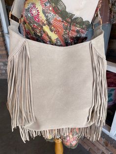 Ivory Leather Beaded Fringe Purse Each bag is unique and totally one of a kind! Room enough for all your daily essentials, this purse matches any bohemian style outfit and more. Featuring tassel and bead details, and so much fun fringe! Approx. 13" x 12" x 3" Zipper closure, 1 inside zipper pocket Chic Fringe Hobo Bag For Travel, Cream Bags With Tassels, Chic Travel Hobo Bag With Fringe, Chic Beige Fringe Shoulder Bag, Chic Beige Fringe Bag, Chic Rectangular Fringe Hobo Bag, Chic Rectangular Hobo Bag With Fringe, Beige Tassel Shoulder Bag For Everyday, Bohemian Bags With Beaded Fringe For Everyday Use