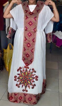 -Custom-made Ethiopian & Eritrean Dress. -This order takes approximately 4-5 weeks to make and deliver. -We will contact you about measurements instructions upon purchase. -You are allowed to change the colors and design. White Traditional Dresses With Traditional Patterns, White Dresses With Woven Motifs For Festivals, White Kaftan With Traditional Patterns, Maxi Length, White Ceremonial Dress For Festivals, Ceremonial White Dresses For Festivals, White Folk Dress With Woven Motifs, White Ceremonial Dress With Traditional Patterns, Ceremonial White Dresses With Traditional Patterns, White Habesha Kemis With Woven Motifs For Traditional Ceremonies