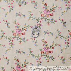 an image of a flowered fabric with two wedding rings on it