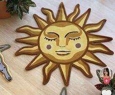 the sun is made out of wood and sits next to some scissors on a table