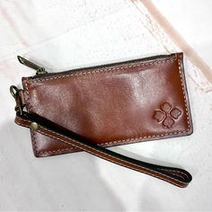 Patricia Nash Almeria Heritage Leather Rfid Credit Card Wristlet Wallet Brown. A Lightweight Credit Card Wallet That Is Great To Throw In Your Bag, But Stylish Enough To Carry On Its Own. The Almeria Features A Detachable Wrist Strap And A Zip Pocket, So You Have The Option To Bring Some Cash And Coins Along With Your Essential Cards. Brand New Without Tags. 100% Full-Grain Leather Embossed With Patricia Nash Signature Logo Zipper Closure 7" Detachable Wristlet Strap Antique Brass-Tone Hardware Classic Wristlet Pouch For Everyday Use, Leather Wristlet Pouch With Card Slots, Classic Everyday Pouch Wristlet, Classic Everyday Wristlet Pouch, Leather Wristlet With Zipper Pouch For Daily Use, Everyday Rectangular Clutch With Rfid Blocking, Rectangular Clutch With Rfid Blocking For Everyday Use, Classic Pouch Wristlet For Daily Use, Brown Wristlet With Card Slots For Daily Use