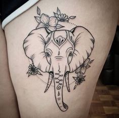 an elephant with flowers on it's head is shown in this tattoo style photo