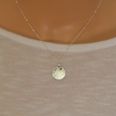 This beautiful simple sterling silver disc charm has been gently hammered to give it a beautiful sheen when the light hits it. It suspends from a sterling silver trace chain.  The disc charm measures 16 mm There is a choice of 14, 16, 18 or 20 inch sterling silver chain. A great everyday wear necklace  The necklace will arrive in a gift box so ready to give to a loved one. Everyday Hammered Coin Necklace With Round Pendant, Hammered Round Disc Coin Necklace As Gift, Hammered Coin Necklace As Gift, Hammered Sterling Silver Necklaces In Silver, Elegant Sterling Silver Round Disc Coin Necklace, Hammered Coin Necklace Gift, Sterling Silver Round Disc Coin Pendant, Simple Hammered Sterling Silver Jewelry, Silver Medallion Coin Necklace With Moon Charm