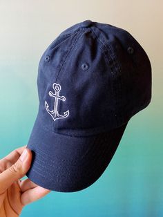 Anchors Away! This custom embroidered baseball hat has the Anchor24 logo complete with a heart at the top. Details: -Navy hat with white embroidery -1 size fits all with adjustable strap -100% brushed cotton -Machine washable Follow us on instagram: @anchortwentyfour  www.instagram.com/anchortwentyfour www.anchortwentyfour.com Navy Cap With Embroidered Logo, Navy Hat With Embroidered Logo And Curved Visor, Navy Baseball Cap With Embroidered Logo And Curved Brim, Navy Curved Bill Hat With Embroidered Logo, Navy Visor Hat With Embroidered Logo, Adjustable Navy Embroidered Hat, Navy Snapback Baseball Cap With Embroidered Logo, Navy Embroidered Logo Snapback Baseball Cap, Navy Dad Hat With Embroidered Logo