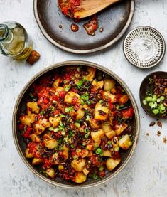 a bowl filled with food sitting on top of a table next to other dishes and utensils