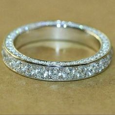 an image of a wedding ring with diamonds on the inside and outside of it's band