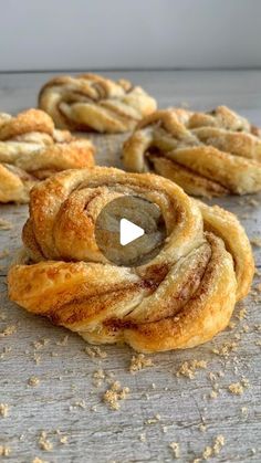 cinnamon rolls on a wooden surface with the top rolled up