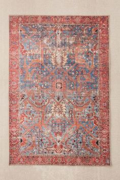 an antique rug with red, blue and orange colors