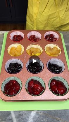 a muffin tin filled with cupcakes covered in jelly