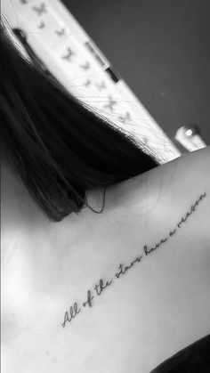 the back of a woman's neck with an inscription on it that says, all we