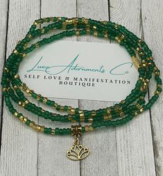 Green & Gold Waist Beads with Lotus Charm - Handmade to Order - Stretch Belly Chain with Clasp - Self Love - Manifestation - Perfect Gift for Her Elevate your self-love journey with our exquisite Green & Gold Waist Beads featuring a delicate lotus charm. These waist beads are not just a beautiful accessory; they symbolize empowerment, manifestation, and a celebration of your unique journey. 🌿 **Symbolic Significance The lush green beads signify growth, renewal, and a deep connection with nature Green Jewelry With 108 Beads For Festival, Adjustable Green Beaded Necklaces For Meditation, Gold Jewelry With 8mm Beads For Festivals, Green Spiritual Jewelry With Tiny Beads, Handmade Adjustable Waist Beads For Gift, Handmade Flexible Jewelry With Round Beads, Green Tiny Beads Waist Beads Gift, Green Waist Beads For Gift, Gold Waist Beads