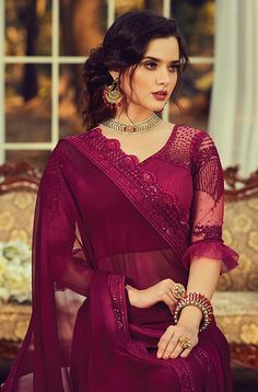 COLOR : Wine FABRIC : Saree - Georgette, Blouse - Georgette & Net WORK : Resham Embroidery, Sequins, Stones, Motifs & Lace BorderOCCASION : Party Wear, Festival READY-TO-WEAR : No STITCHING : Available as semi-stitched fabric, can be stitched using standard size option (+$20). Note: There might be a slight color variation due to lighting and flash used during photoshoot. The bright shade seen is the best closer view of fabric's color. Resham Embroidery, Saree Designs Party Wear, Party Wear Saree, Saree Photoshoot, Satin Saree, Georgette Blouse, Party Wear Indian Dresses, Wear Saree, Party Wear Sarees