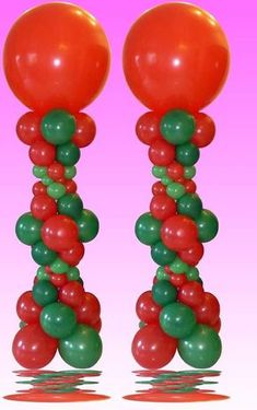 two tall red and green balloons on top of each other