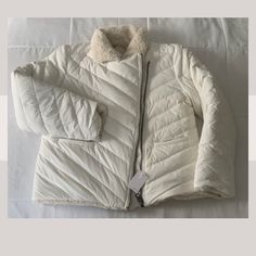 Winter Size Xl Down Nylon Shearling Ecru Reversible Regular Two For One! Who Doesn't Love A Reversible Jacket? On One Side, Down-Filled Slick Weather Friendly Nylon Quilted In A Chevron Pattern. On The Other, A Super Soft And Plush Faux Shearling. New With Tags - Pristine, Never Used Condition. Tags Still Attached. Send Me Offers Please! Cream Nylon Outerwear For Fall, White Quilted Puffer Jacket For Cold Weather, White Nylon Outerwear With Zipper Closure, White Sherpa Outerwear For Fall, Winter White Sherpa Outerwear With Fleece Lining, Quilted White Outerwear For Cold Weather, White Quilted Outerwear For Cold Weather, White Fleece-lined Outerwear For Spring, Neutral Quilt