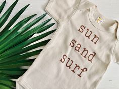 Go for a dip with our Sun Sand Surf Baby Bodysuit. This gender neutral, short sleeve onesie is perfect for any beach-loving babe. With a playful vibe and cool design, your little one will be ready to catch some waves (or just some z's). Time to soak up some fun in the sun! Onesie Ideas, Surf Baby, Pray For Surf, Sand Surfing, Baby G, Beach Baby, Fun In The Sun, Cool Design, Beach Themes