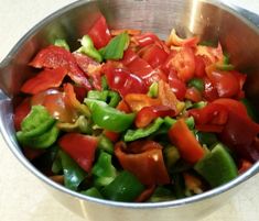 a metal bowl filled with lots of vegetables