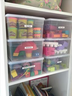 the shelves are filled with plastic toys and books for kids to play in or use