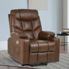 a brown recliner chair sitting on top of a rug