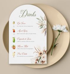 a menu with flowers and drinks on it next to a white plate that says drinks