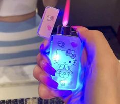 a person holding a hello kitty lighter in their hand