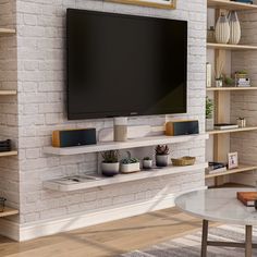 a flat screen tv mounted to the side of a white brick wall in a living room