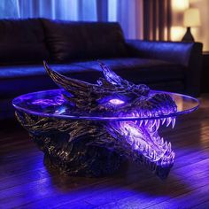 a glass table with a dragon head on it in the middle of a living room