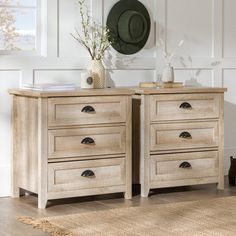 two wooden dressers sitting next to each other in a room