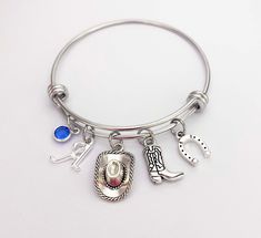 Cowgirl Charm Bracelet personalized country girl gifts. This cowboy hat bangle makes great cowgirl gifts, rodeo gifts, birthday gifts or Christmas gift for girls, for teens and for women. COMES READY FOR GIFT GIVING Stainless Steel Adjustable Bracelet includes: *Swarovski birthstone, 6mm *Silver plated initial charm *Antique silver cowboy hat charm *Antique silver cowboy boot charm *Zinc alloy Horse Shoe Charm Adjustable bangle bracelet is Stainless Steel - It won't rust or tarnish. The inner di Country Girl Gifts, Rodeo Gifts, Country Birthday, Jewelry Western, Cowgirl Gifts, Country Stuff, Cowgirl Jewelry, Adjustable Bangle Bracelet, Kids Bracelets