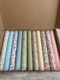 a box filled with lots of different colored wrapping paper