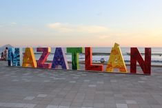 there is a large sign that says zaatan on the beach