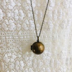 "Vintage brass ball locket. Measures 3/4\" round. Made in the 1970's it has beautiful patina. Opens and shuts tightly. It can hold two teeny, tiny, pictures. 1/2\" or smaller. Perfect necklace for layering. You may choose the length of your choice in the drop down menu above. Last photo shows the same locket available in a dark brass: https://www.etsy.com/listing/693755952/hidden-locket-necklace-bee-secret?ref=shop_home_active_8&pro=1&frs=1 I offer quick shipping and all packages will ar Secret Compartment Necklace, Etsy Coupon Codes, Unique Locket, Bee Wings, Handwritten Gifts, Locket Design, Sweet Necklace, Jewelry Safe, Bird Necklace