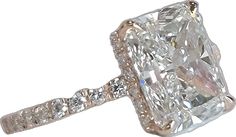 an engagement ring with a cushion cut diamond in the center and pave set shoulders