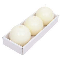 two white candles in a box on a white background