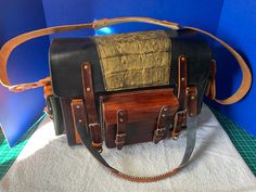 This is a large, handcrafted, leather messenger or carry-on bag.  It has two side pockets, a front pocket, and a zippered pocket in the back. Dimensions are:  30 inches long, by 8 inches wide, by 10 inches tall total.  The pockets are each 2 inches deep. Note that the gold caiman skin on the cover is an optional add-on for $20.  Please let me know in the notes after purchase if you would like this.  The cover is plain leather otherwise. Multi-colored options are available at no extra charge.  Pl Leather Satchel Shoulder Bag With Multiple Pockets, Luxury Leather Bags With Multiple Pockets, Leather Crossbody Bag With Multiple Pockets, Brown Satchel Shoulder Bag With Multiple Pockets, Brown Shoulder Satchel With Multiple Pockets, Brown Leather Bag With Multiple Pockets, Doctor Outfit, Bowler Hat, Belt Pouch