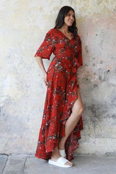 Our Boho Wrap Maxi Dress in red is the ultimate boho-chic statement outfit. Effortlessly elegant, sustainably made, and designed to make you stand out. V-neck Floral Print Boho Dress For Party, Bohemian V-neck Maxi Dress For Brunch, Bohemian Rayon Maxi Dress With Ruffles, Fitted V-neck Boho Dress With Ruffles, Flowy Wrap Dress For Fall, Summer Wrap Dresses For Date Night, Chic Flowy Rayon Boho Dress, V-neck Boho Dress With Ruffles For Festival, Bohemian Maxi Dress With Ruffle Hem For Party