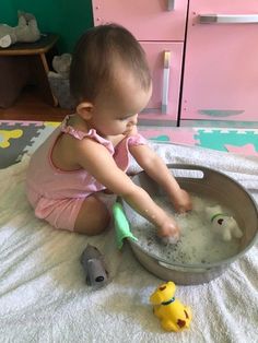 a toddler playing with toys in a play room