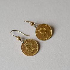 A beautiful and closely matched pair of antique 22ct gold 1 US dollar coin earrings. Each coin depicts Liberty in profile. One is dated 1855 and the other is dated 1861. each coin measures 15 mm in diameter. With later antique hook fittings added to create aesthetic earrings. Please note the box shown is for demonstration purposes. Measurements: total drop measures 30 mm Weighs: 3.95 grams combined Hallmarks: none, coins are 22ct gold and hook fittings test as 9ct gold Create Aesthetic, Aesthetic Earrings, Antique Coins, Coin Earrings, Dollar Coin, Gold Coins, 22k Gold, Jewelry Earrings Dangle, Dangle Drop Earrings